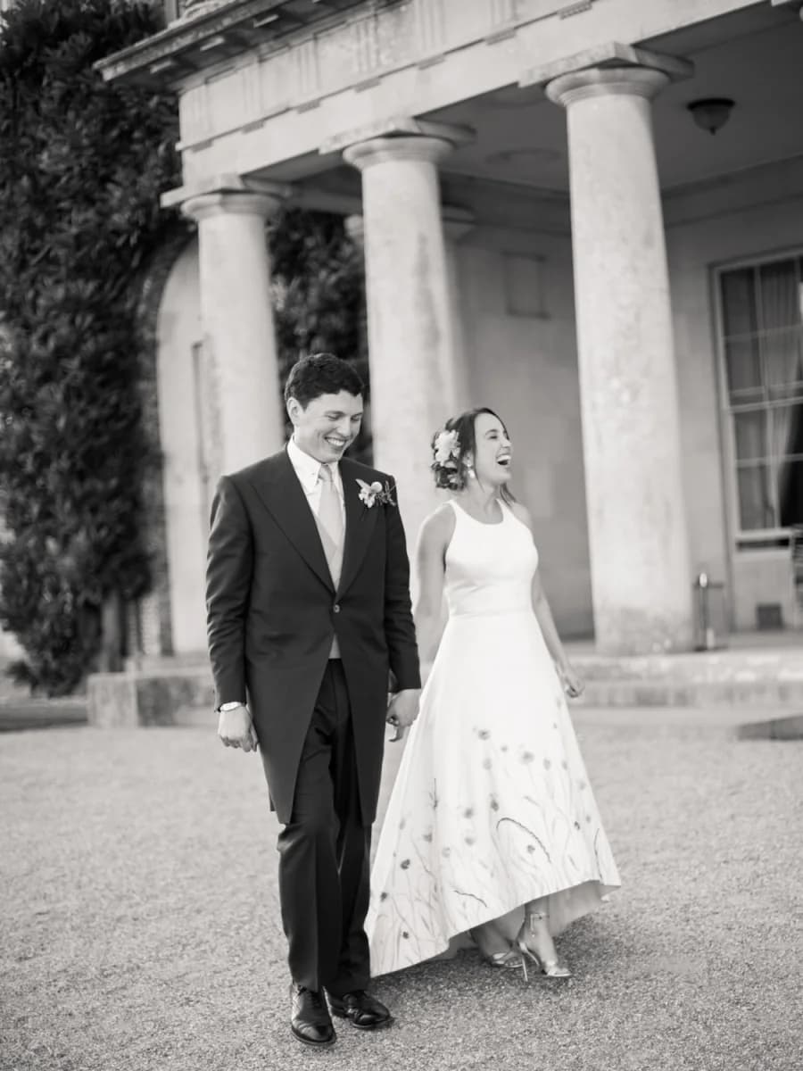 Newlyweds laughing outside Goodwood House