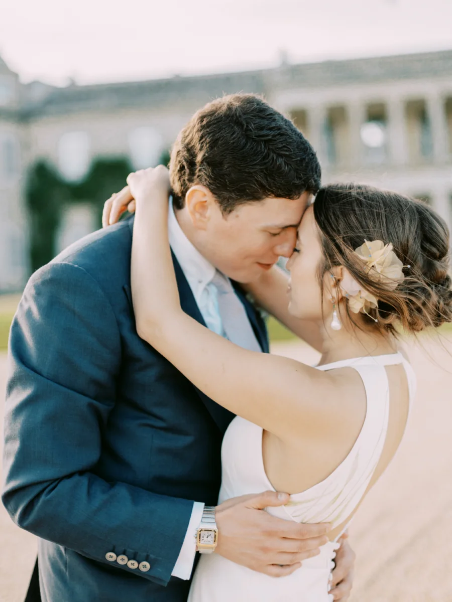 Newlyweds embracing in the Goodwood House gardens
